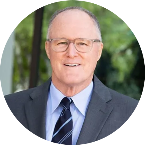 A man in suit and tie smiling for the camera.