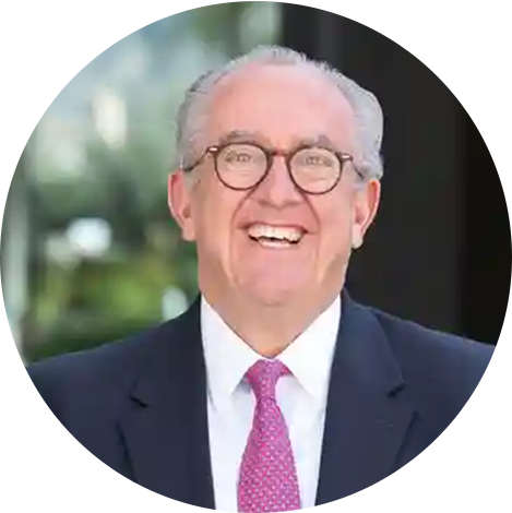A man in suit and tie smiling for the camera.