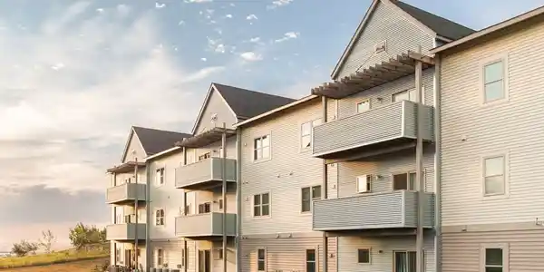 A row of apartments with balconies on the side.