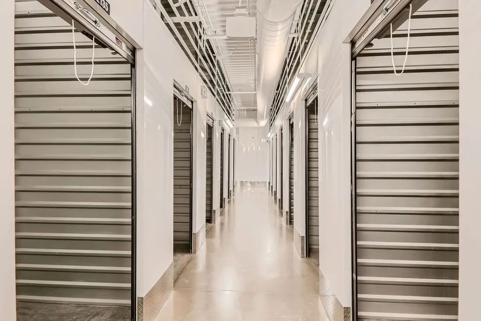 A long hallway with many doors and windows.