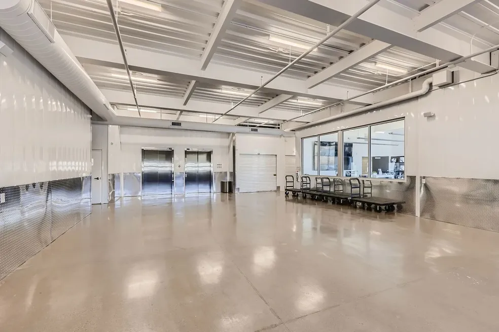 A large room with many tables and chairs.