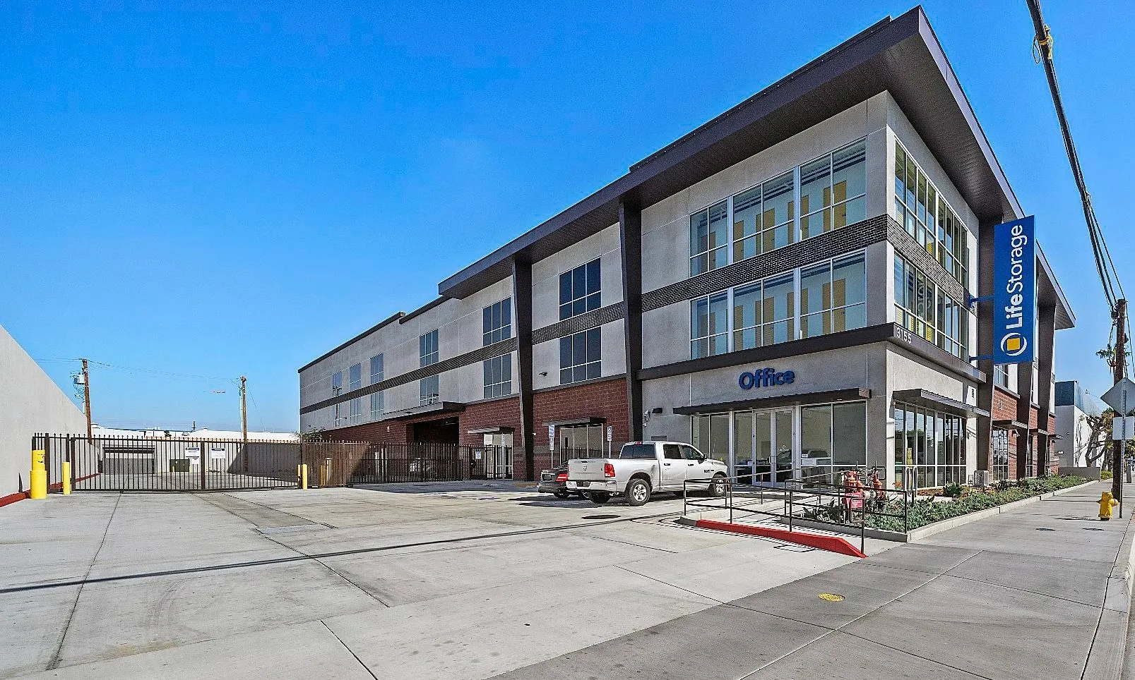 Modern storage facility with parking lot.