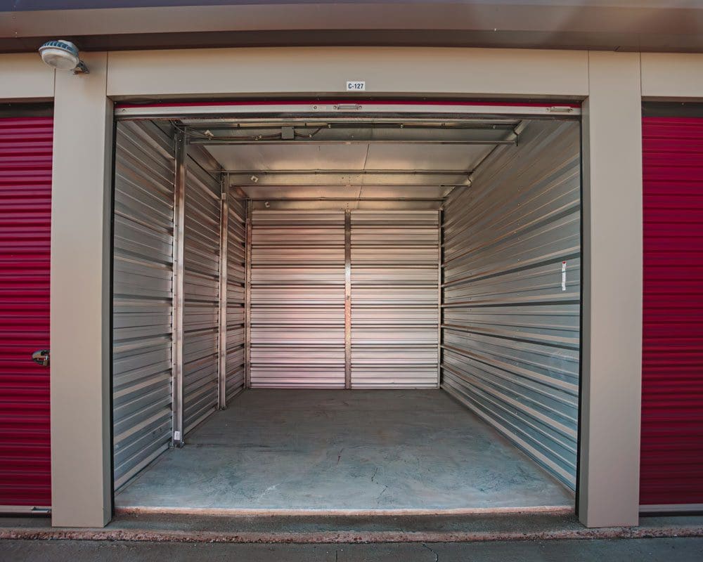 Daytime photo of storage unit with open door showing clean interior at Storage 85 in Watford City ND