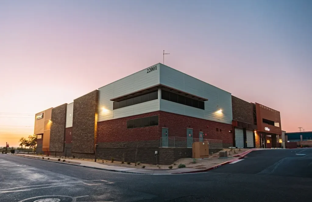 A large building with a parking lot in front of it.