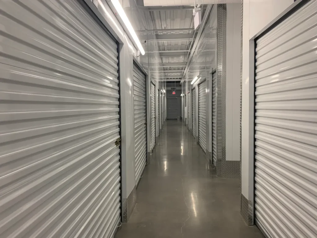 A long hallway with many doors and lights