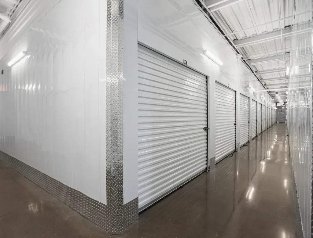 A long hallway with many doors and windows.