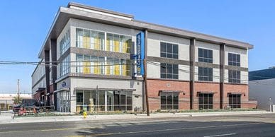 Photo of multi-level building with windows and brick accents