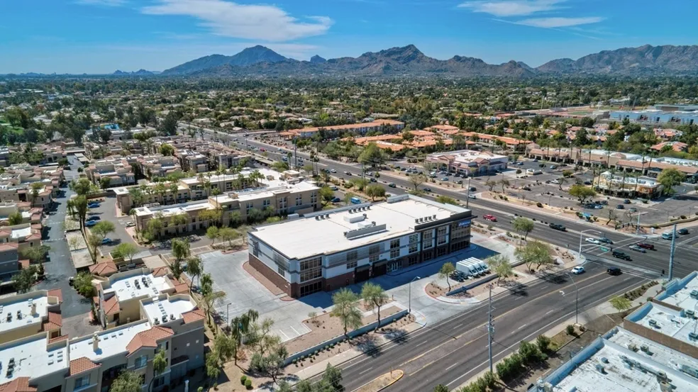 An aerial view of a building with mountains in the background.