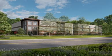 Rendering of multi-level building with windows and brick accents