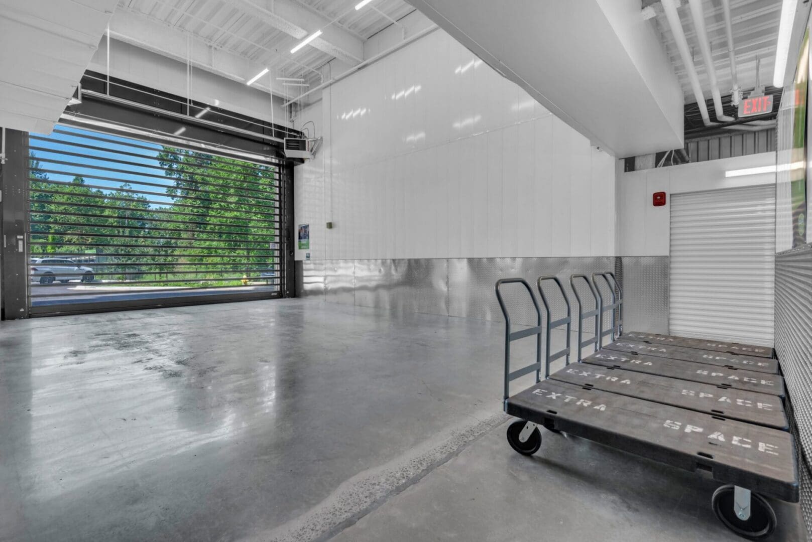 Interior storage loading bay with moving carts