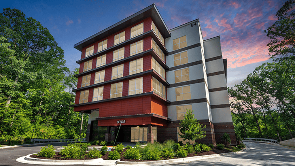 Mulit-story storage facility with windows and brick accent