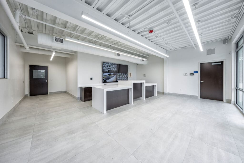 White and clean storage leasing office with security video screens