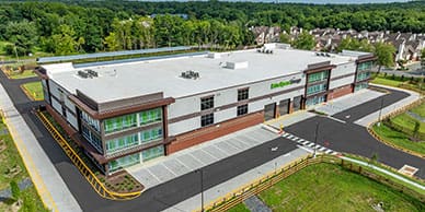 Aerial photo of a multi-story storage building with glass and brick accents
